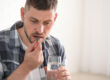 individual taking pill in MAT for addiction treatment