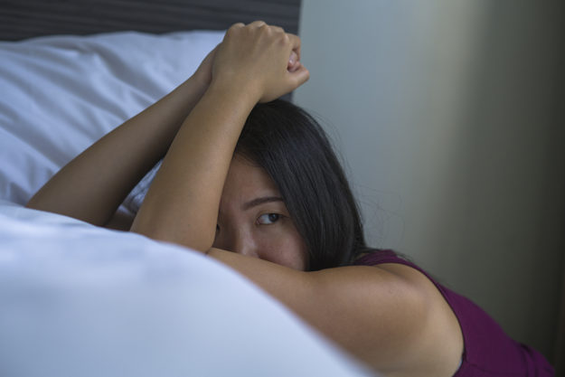 signs of heroin addiction (1) woman leaning on her bed showing signs of heroin addiction
